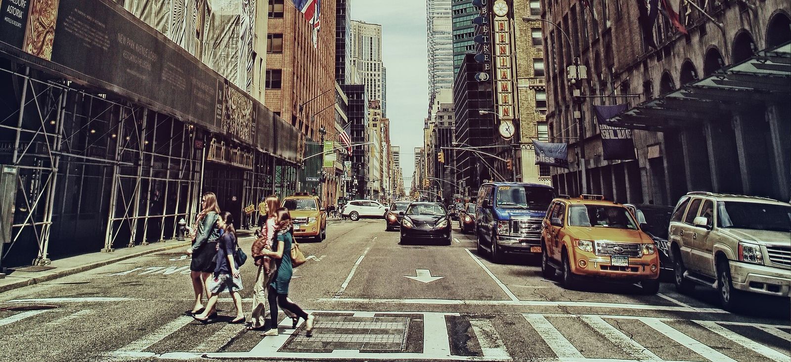Street scene under video annotation: vehicles carry tracked bounding boxes with persistent IDs.